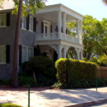 Freshly washed Charleston single house with clean brick driveway ready for listing photos