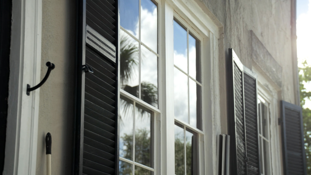 Window Cleaning Cost in Charleston: What to Expect 1 Streak free clean windows on a historic Charleston home with black shutters
