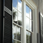Streak free clean windows on a historic Charleston home with black shutters