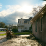 Charleston home driveway covered in palm fronds and storm debris as skies clear after a tropical system